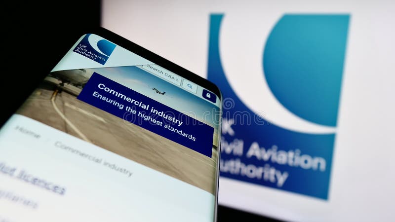 Stuttgart, Germany - 03-12-2023: Smartphone with webpage of British regulator Civil Aviation Authority (CAA) on screen in front of logo. Focus on top-left of phone display. British standards logo stock images, royalty-free photos and pictures