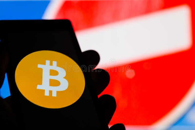 Smartphone à disposition avec le logo de cryptocurrency de Bitcoin En interdisant le rouge connectez-vous le fond photos stock Smartphone à disposition avec le logo de cryptocurrency de Bitcoin En interdisant le rouge connectez-vous le fond photos stock