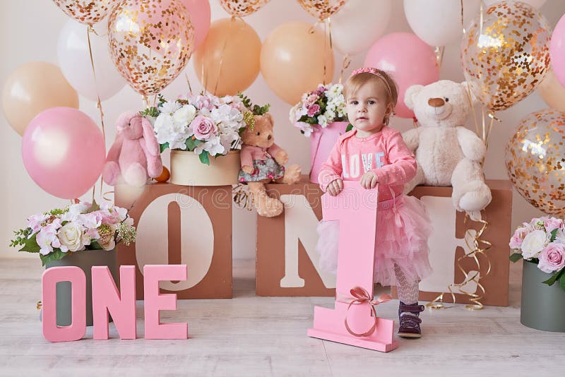 Smash cake party. Little cheerful birthday girl with first cake. Happy infant baby celebrating his first birthday. Decoration and