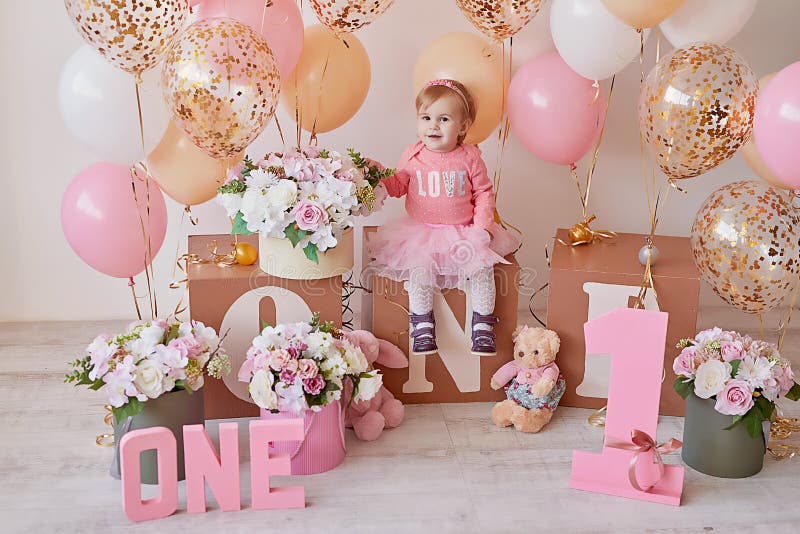 Smash cake party. Little cheerful birthday girl with first cake. Happy infant baby celebrating his first birthday. Decoration and