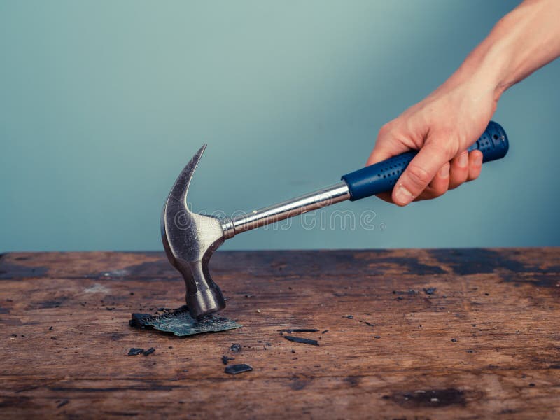 Smashing a computer chip with hammer