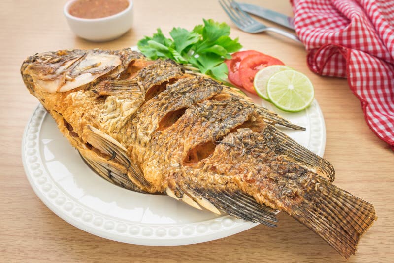 Fried fish on a white plate and dip sauce. Fried fish on a white plate and dip sauce