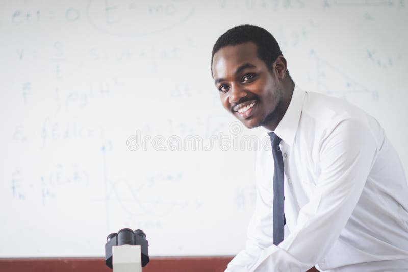 Smile African Teacher in White Shirt is Experimenting and Explaining a