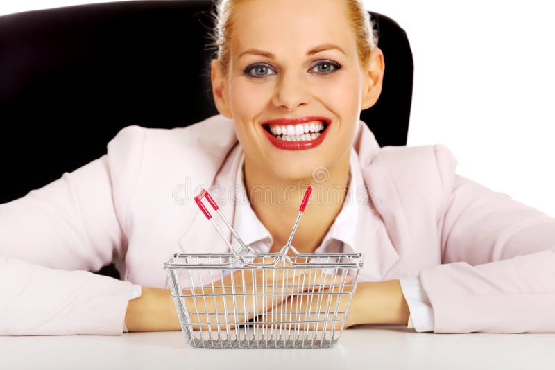 Smile Business Woman Sitting Behind the Desk with Small Shopping Basket