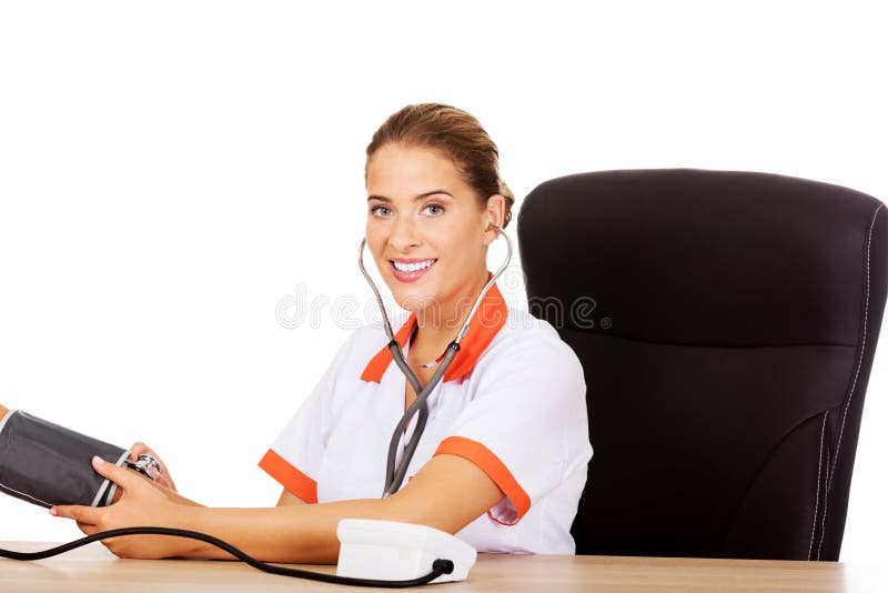 Smile female doctor or nurse checking blood pressure patient royalty free stock photo Smile female doctor or nurse checking blood pressure patient royalty free stock photo
