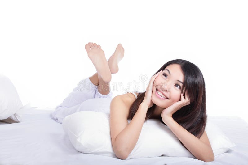 Smile girl lying on bed and look up forward