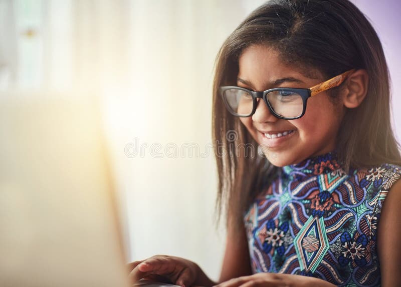 Smile, laptop and kid in home school for elearning, studying and remote online education. Child, computer and girl stock image