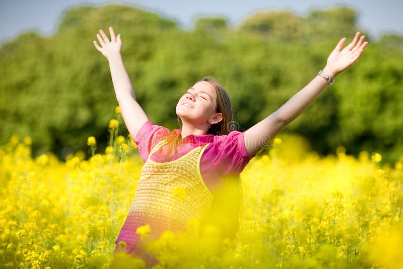 Smile teen open hands standing on yellow field