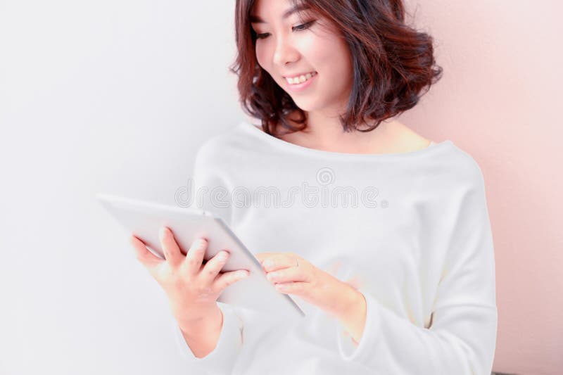 Smile young asian woman use tablet computer royalty free stock photography Smile young asian woman use tablet computer royalty free stock photography