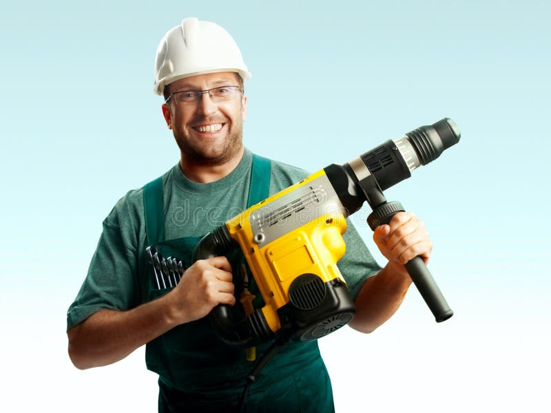 Smiled workman in helmet hold perforator