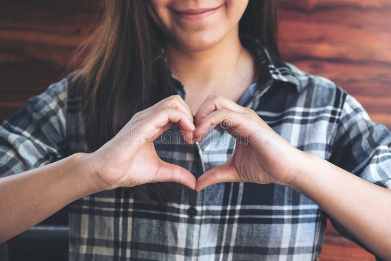 Asian woman making heart hand sign with feeling inlove stock photos