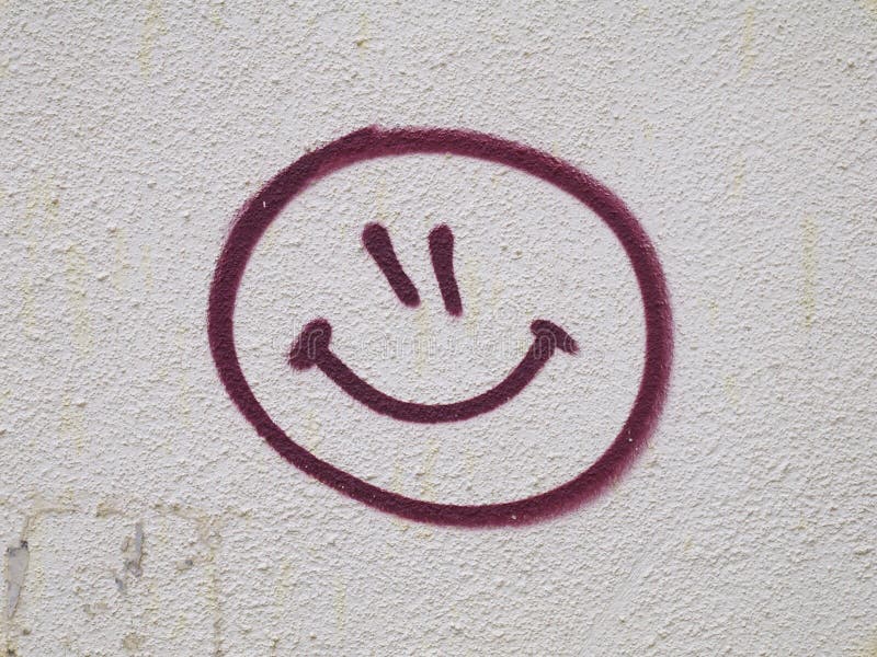 Smiley face graffiti drawn on wall