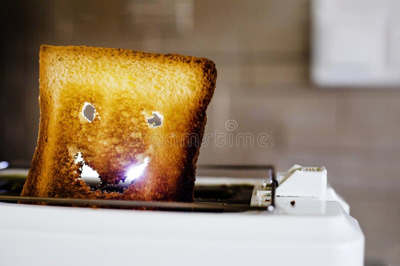 Smiley Face from a Hot Slice of Toasted White Bread in a Toaster
