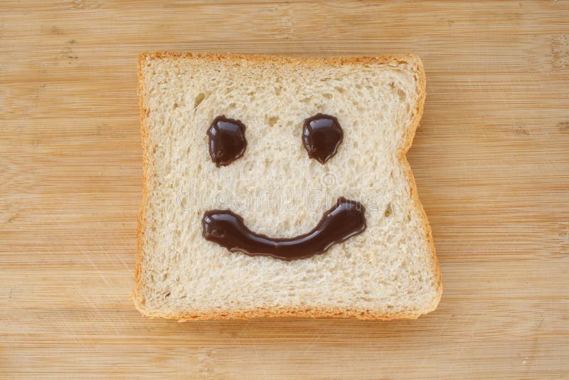 Smiley face on a piece of black bread. 