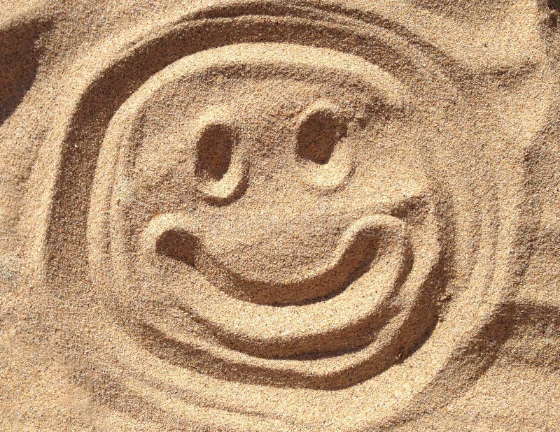 Smiley Face in the sand stock image. Image of exotic 36557817