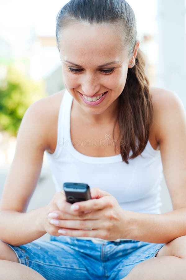 Smiley woman writing text message