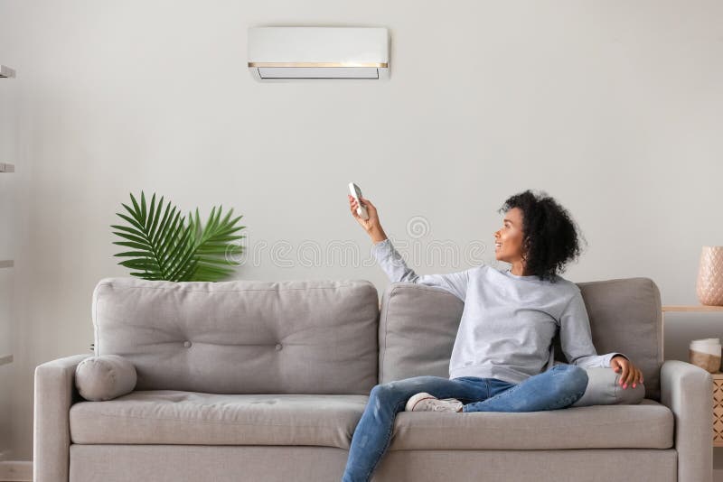 https://thumbs.dreamstime.com/b/smiling-african-american-woman-using-air-conditioner-remote-controller-young-cooler-system-switching-setting-comfort-temperature-147751853.jpg