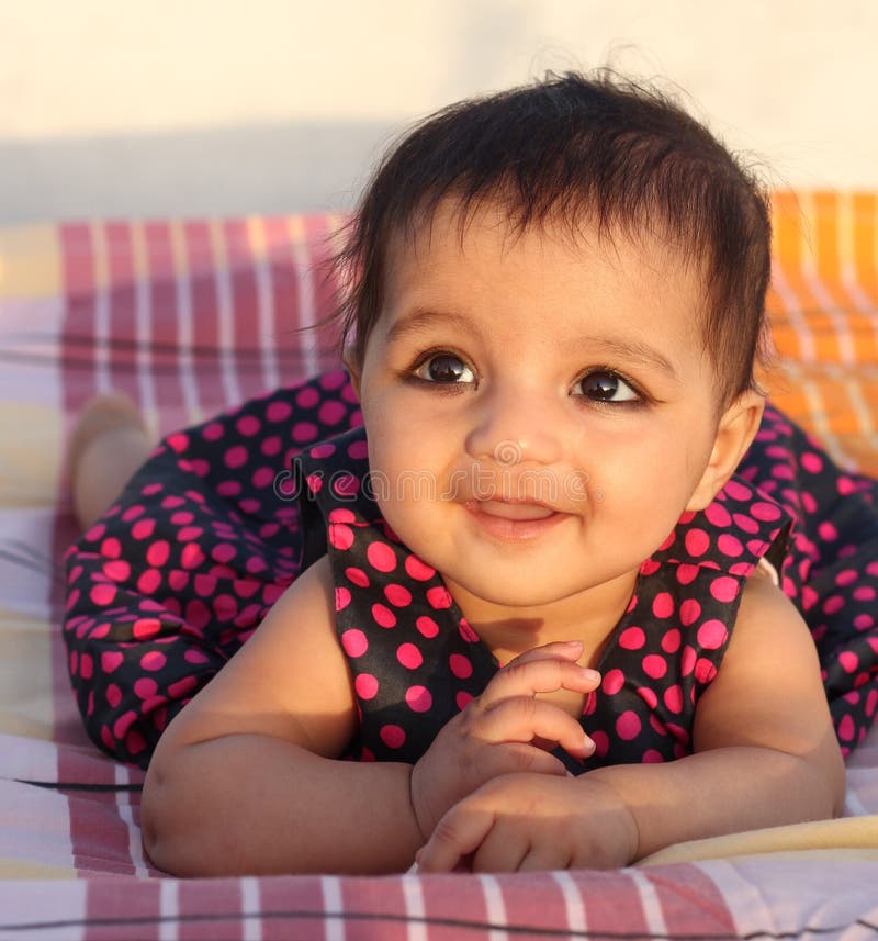 Smiling Asian Baby Girl Looking At The Viewer Stoc