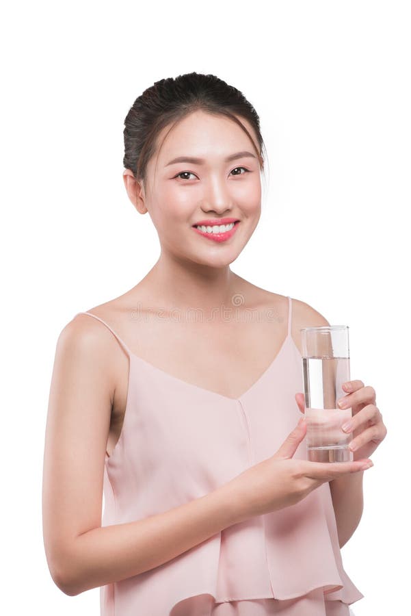 Smiling asian female model holding transparent glass in her hand stock image Smiling asian female model holding transparent glass in her hand stock image