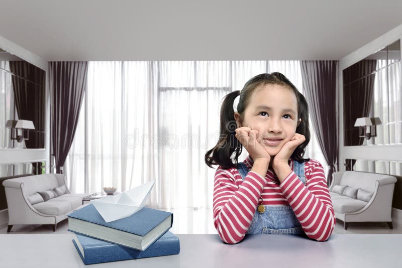 Smiling asian girl with book imagine something royalty free stock image