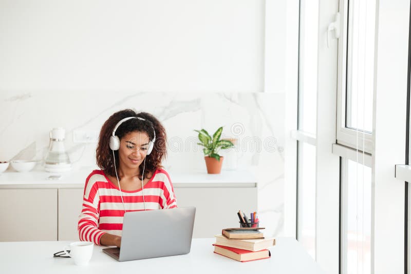 Smiling Attractive african woman using laptop computer royalty free stock photo Smiling Attractive african woman using laptop computer royalty free stock photo