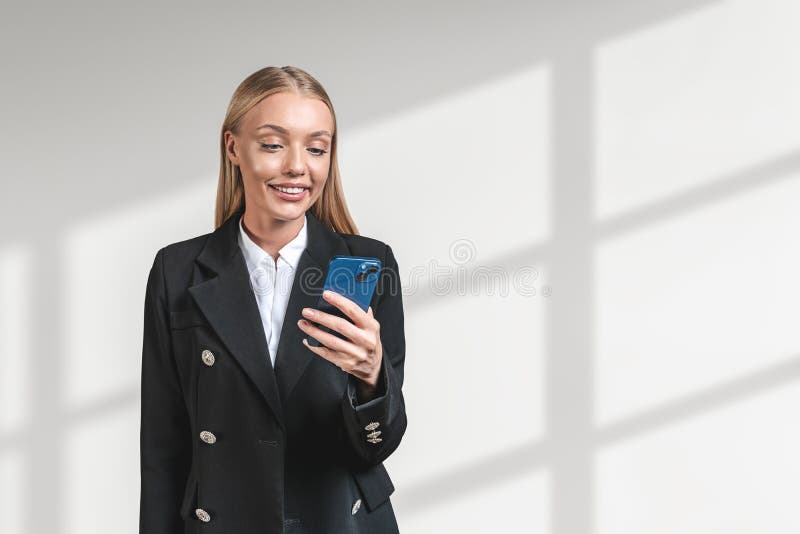 Smiling attractive businesswoman in formal wear standing holding stock photo