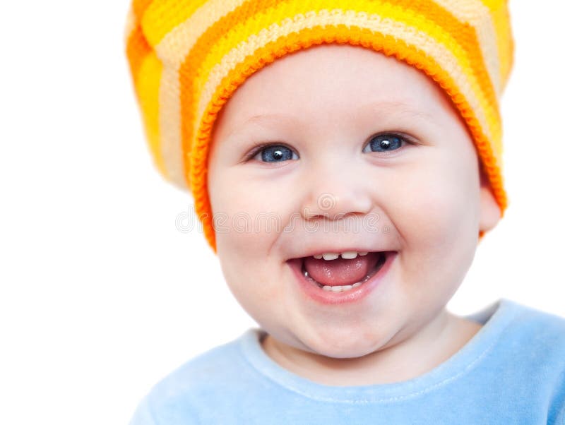 Smiling baby girl showing teeth wearing a hat