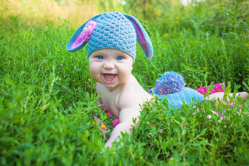 Smiling baby kid posing like an Easter bunny. Happy child