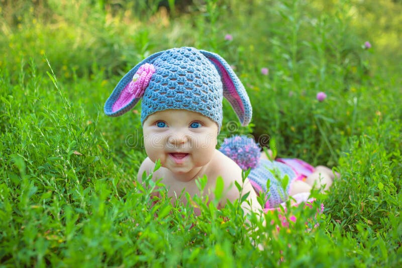 Smiling baby kid posing like an Easter bunny