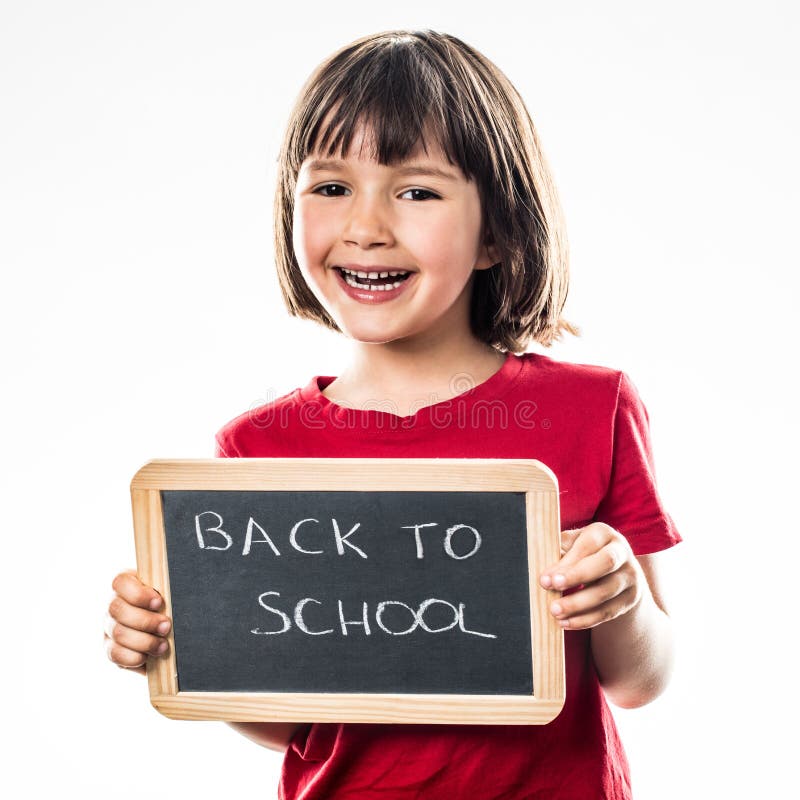 Smiling beautiful preschool girl informing on a writing slate about a cool back to school, white background studio. Smiling beautiful preschool girl informing on a writing slate about a cool back to school, white background studio