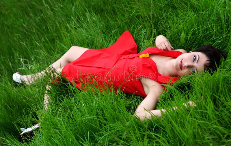 Smiling beautiful woman laying on grass