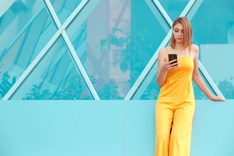 Smiling beautiful woman texting on her smart phone stock photos Smiling beautiful woman texting on her smart phone stock photos