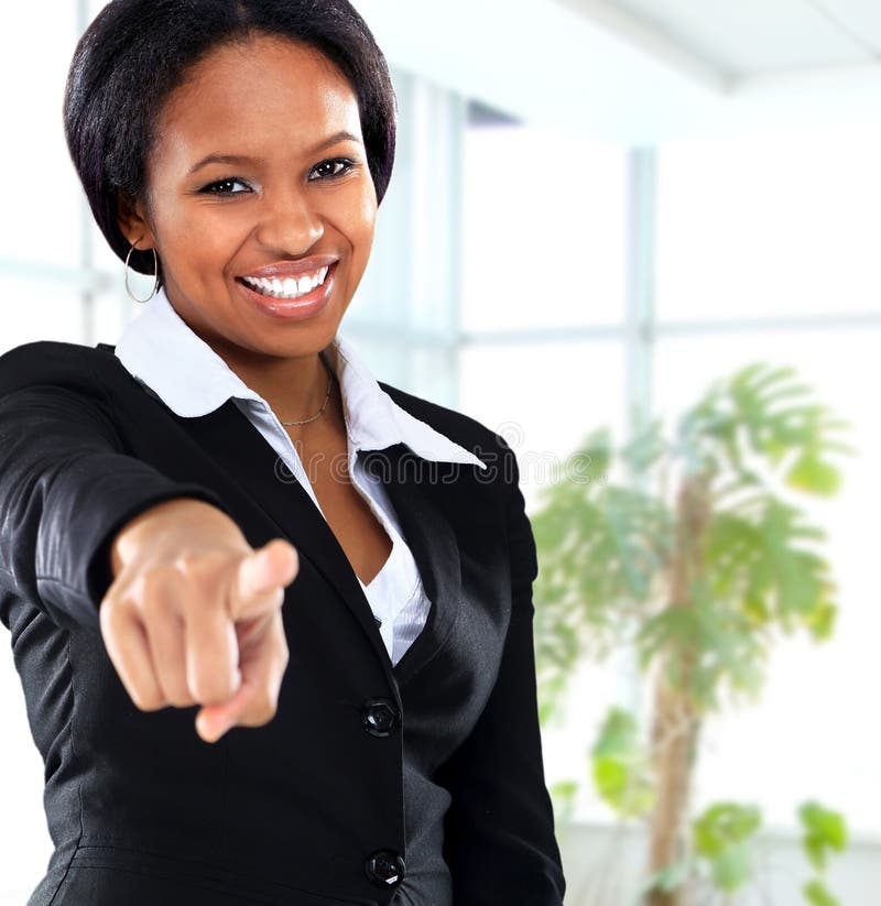 Smiling black business woman pointing