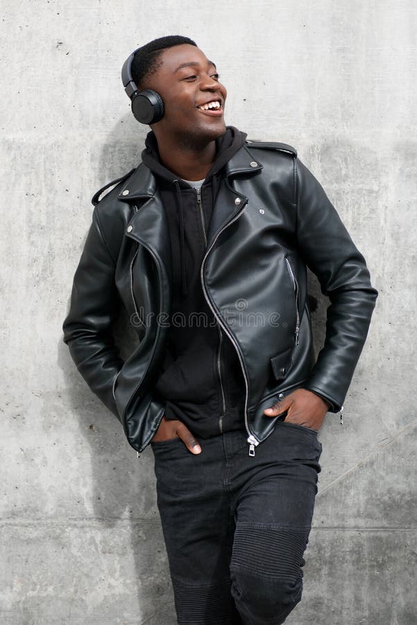 Smiling Black Man in Leather Jacket Listening To Music with Headphones ...