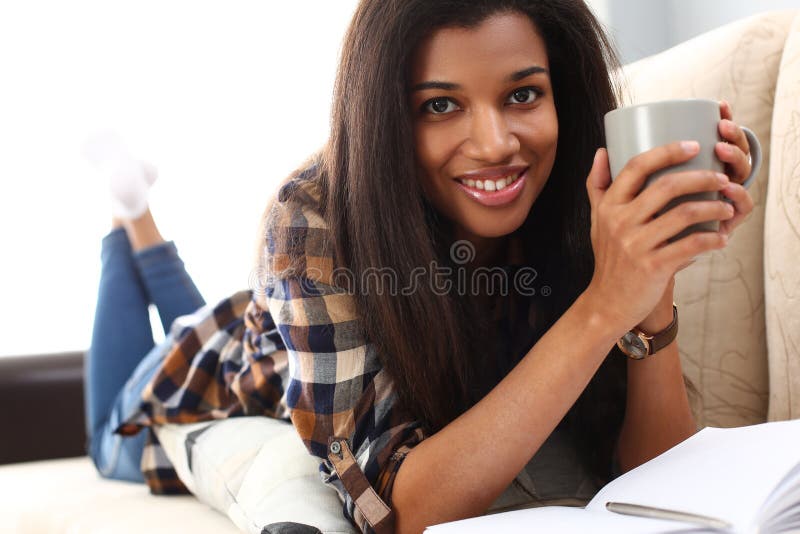 Smiling Black Woman Lie Down At Sofa With Cup Of Hot Beverage Stock Image Image Of Portrait