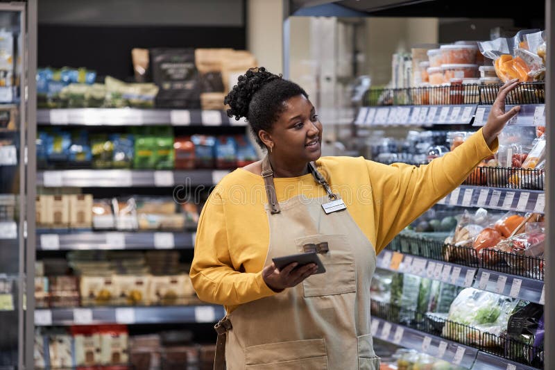 Smiling Black Woman Working in Supermarket and Wearing Apron Stock ...