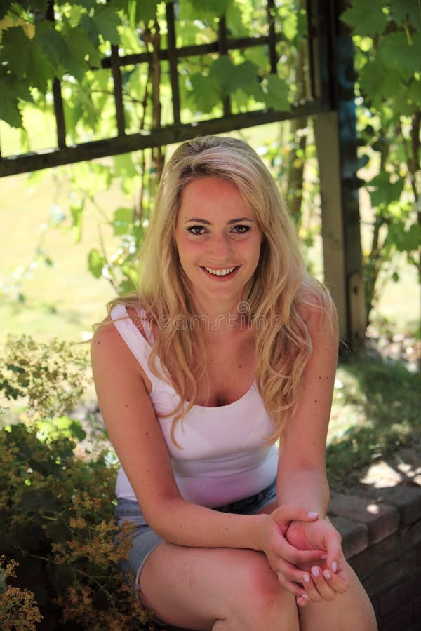 Smiling blond woman relaxing in the shade