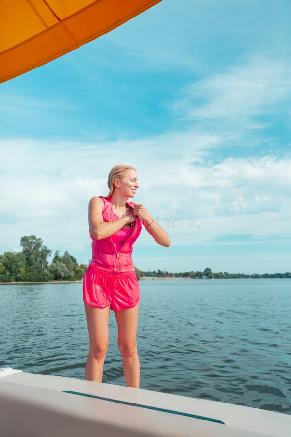 Smiling blonde long-haired young woman in wet clothes stock photos Smiling blonde long-haired young woman in wet clothes stock photos