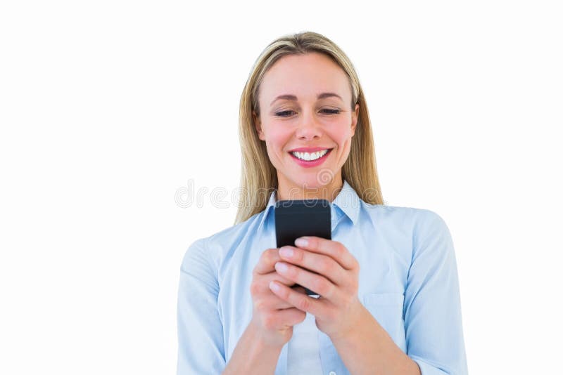 Smiling blonde sending a text message