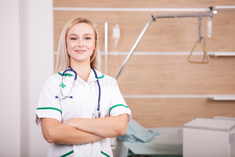Smiling blonde woman doctor on hospital background. Handsome, computer.