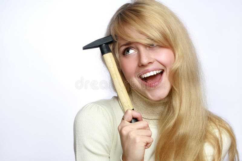 Smiling blonde woman with hand hammer