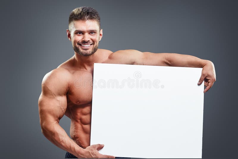 Smiling Bodybuilder Holding Blank White Poster Stock Image 