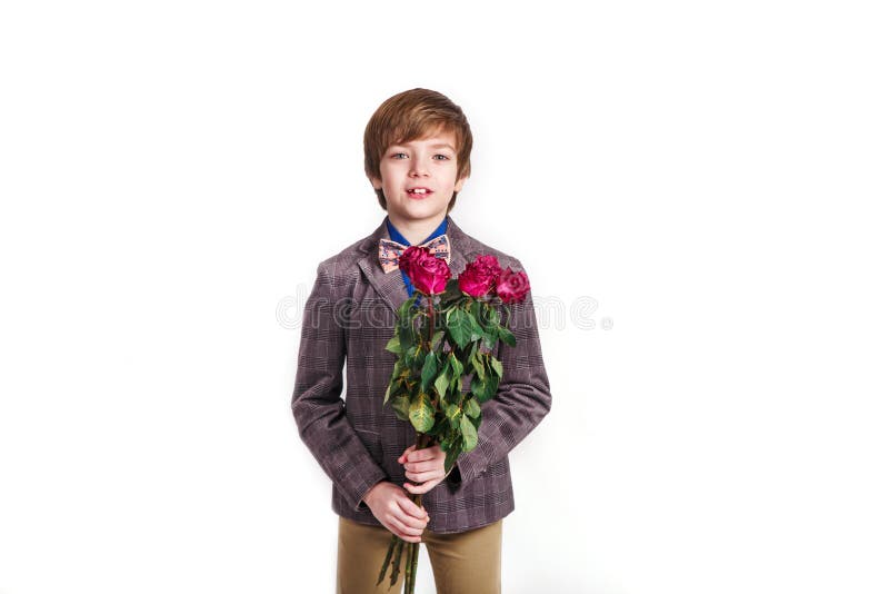 Smiling boy with a bouquet of red roses. Valentine`s day, March 8, Mother`s Day