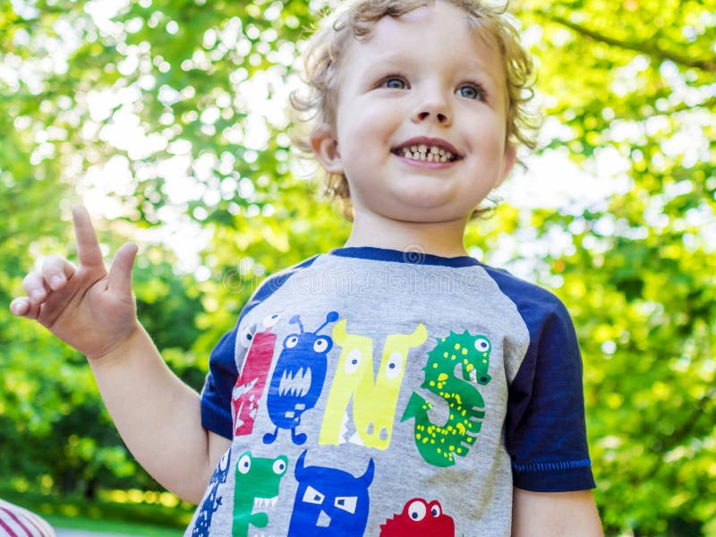 Smiling boy on his walk in summer park