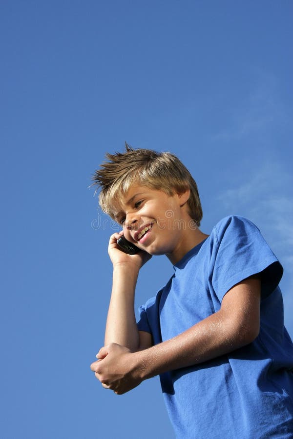 Smiling boy phoning with cell phone