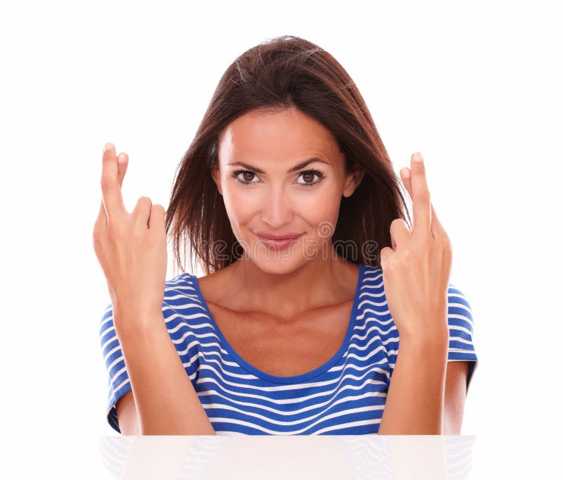 Smiling brunette making a wish sign royalty free stock photos Smiling brunette making a wish sign royalty free stock photos
