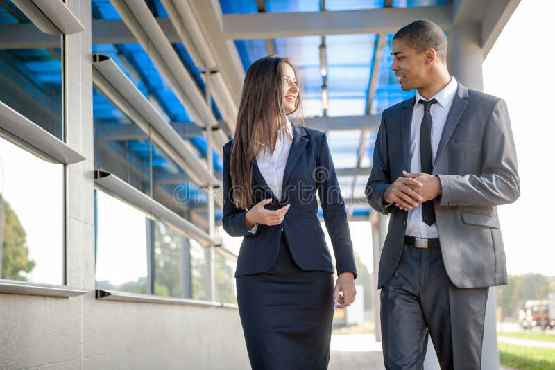 Smiling business man and woman on break ,walking around and talk stock photo Smiling business man and woman on break ,walking around and talk stock photo