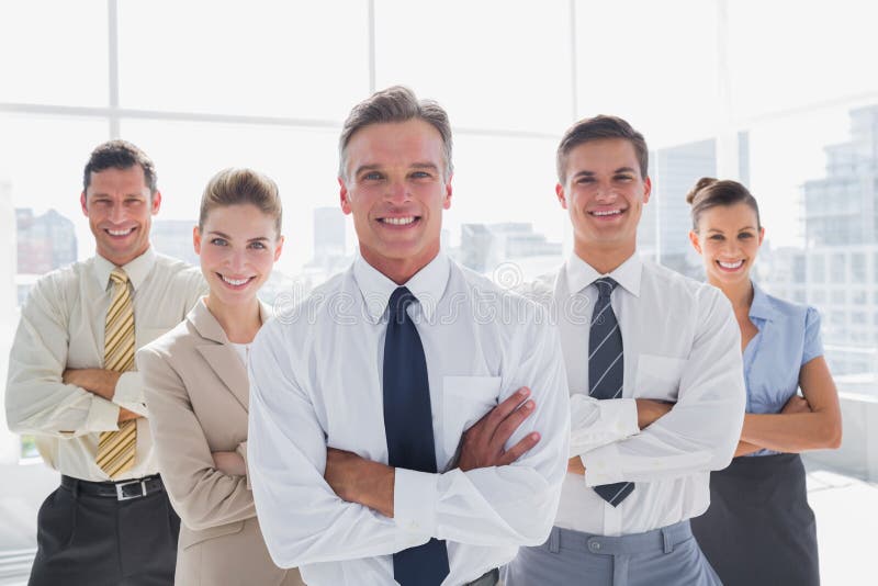 Smiling business people with arms crossed in their office