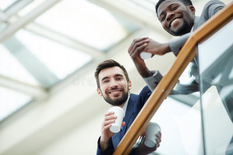 Smiling Business People on Office Building Balcony