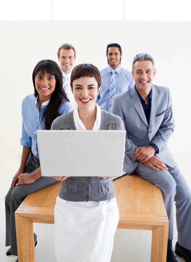 Smiling business people using a laptop